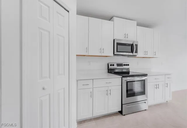 a kitchen with cabinets and stainless steel appliances