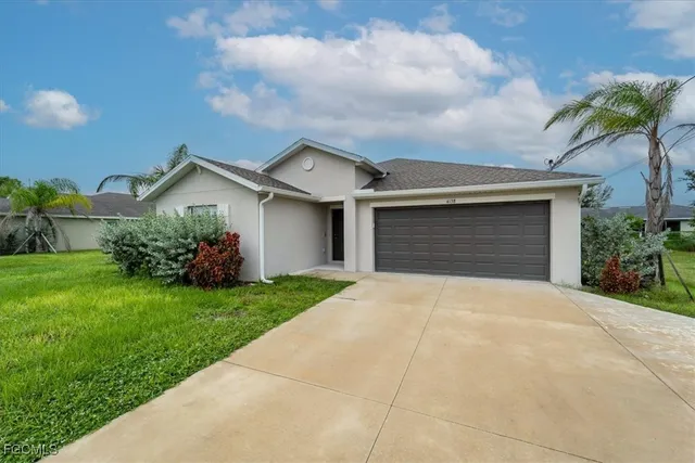 a front view of house with yard and green space
