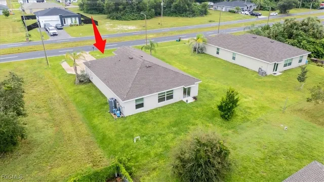 an aerial view of residential houses with outdoor space and swimming pool