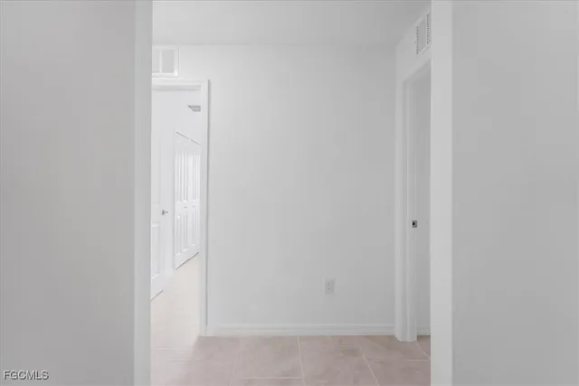a view of an empty room and a window