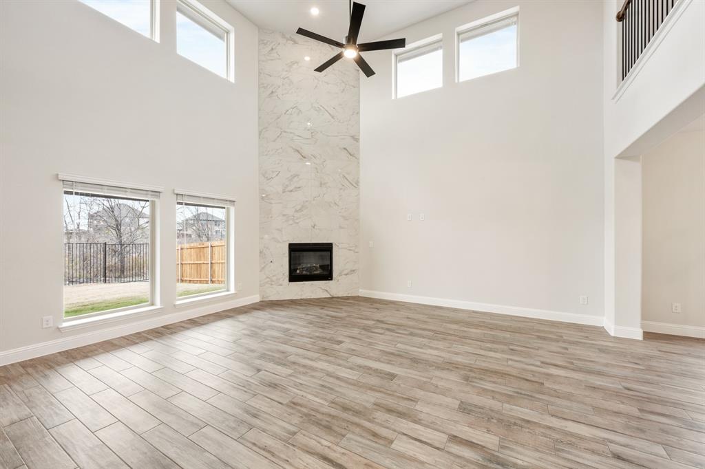 1630 Secco Way Rockwall, TX 75032 - Photo 13 of 40 a view of an empty room with wooden floor and a window