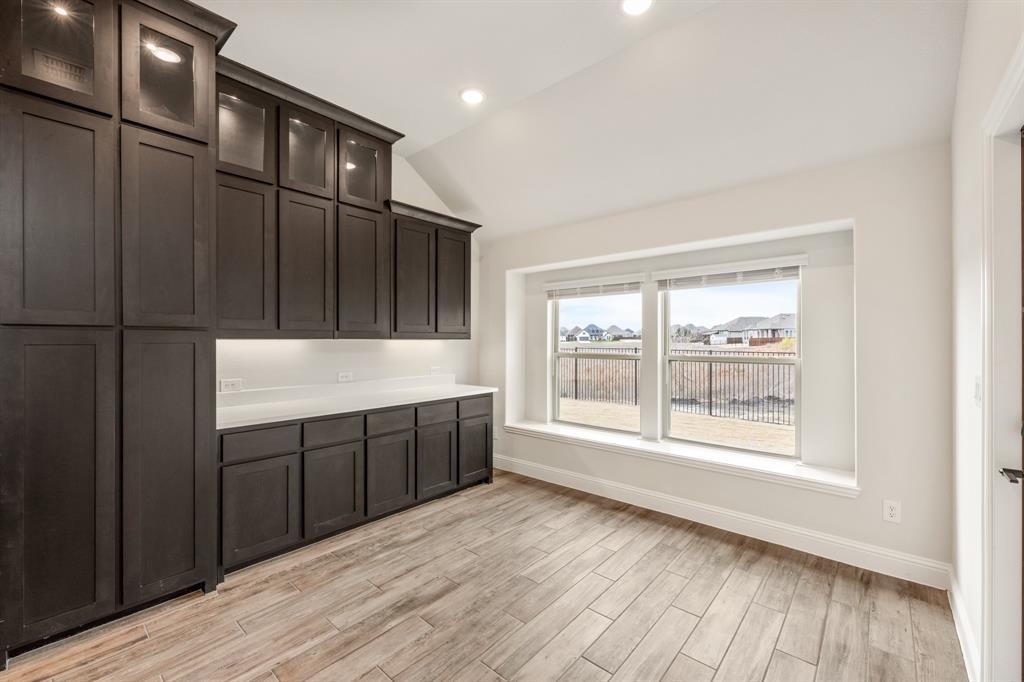 1630 Secco Way Rockwall, TX 75032 - Photo 17 of 40 a view of an empty room with wooden floor and a window