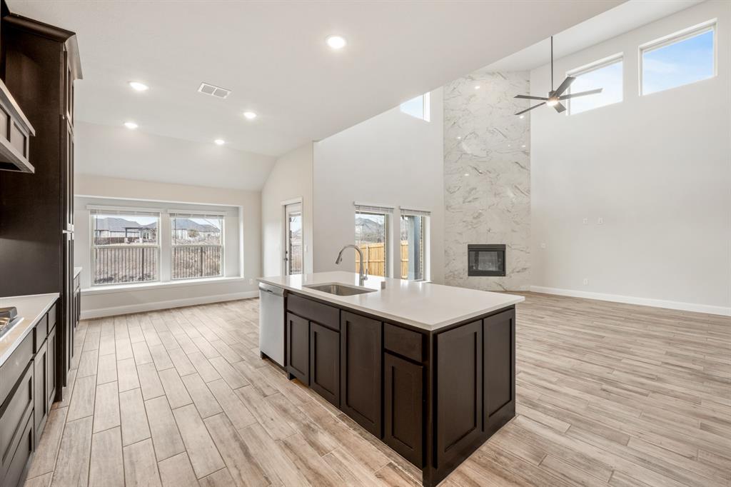 1630 Secco Way Rockwall, TX 75032 - Photo 19 of 40 a kitchen with a sink and wooden floor