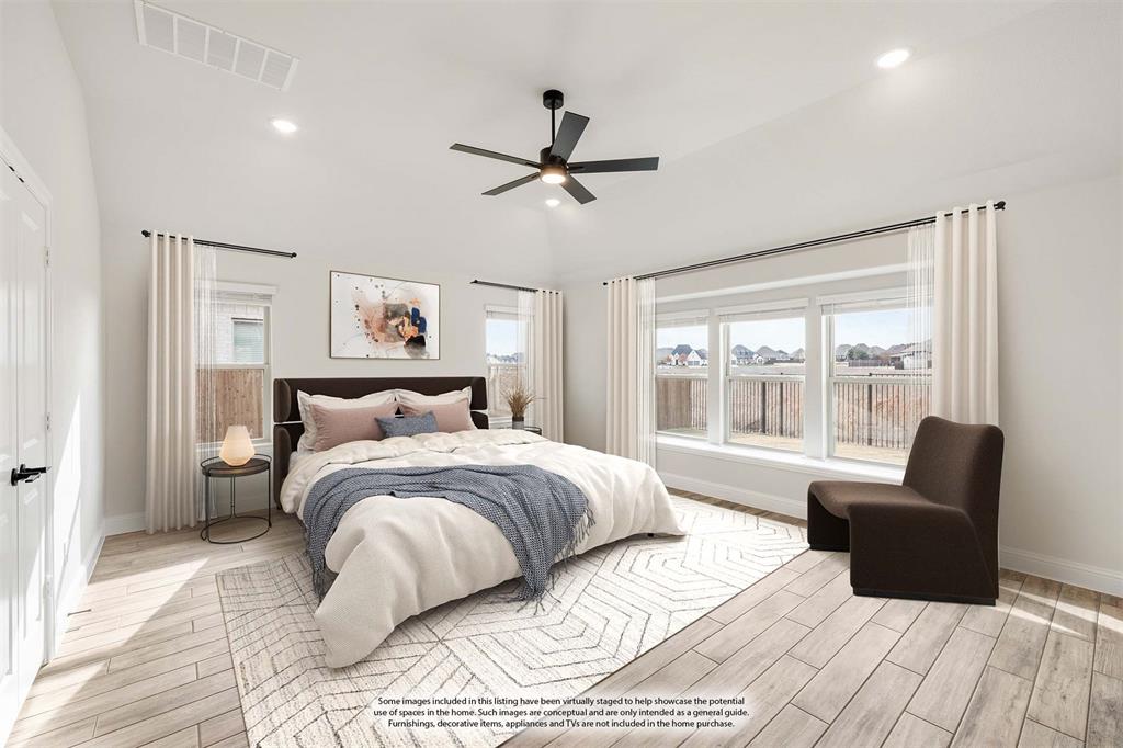 1630 Secco Way Rockwall, TX 75032 - Photo 21 of 40 a bedroom with a bed and glass window