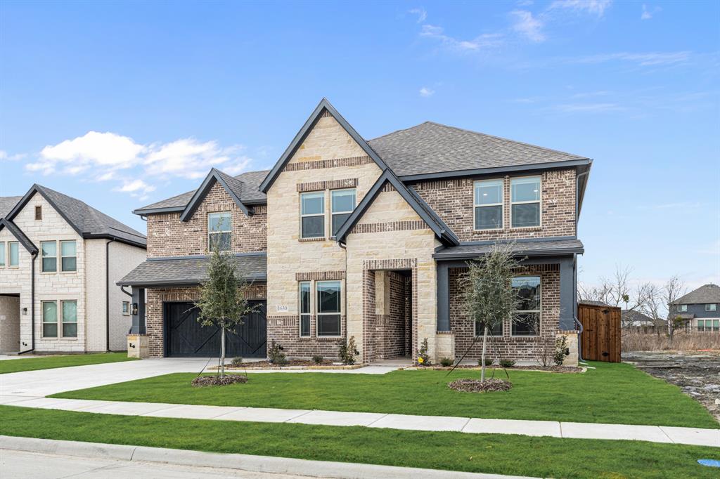 1630 Secco Way Rockwall, TX 75032 - Photo 3 of 40 a front view of a house with a yard
