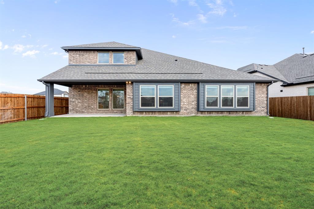 1630 Secco Way Rockwall, TX 75032 - Photo 38 of 40 a brick house with a yard