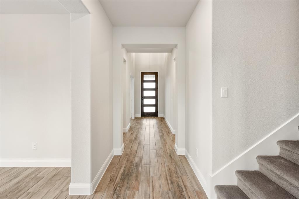 1630 Secco Way Rockwall, TX 75032 - Photo 5 of 40 a view of a hallway with wooden floor and staircase