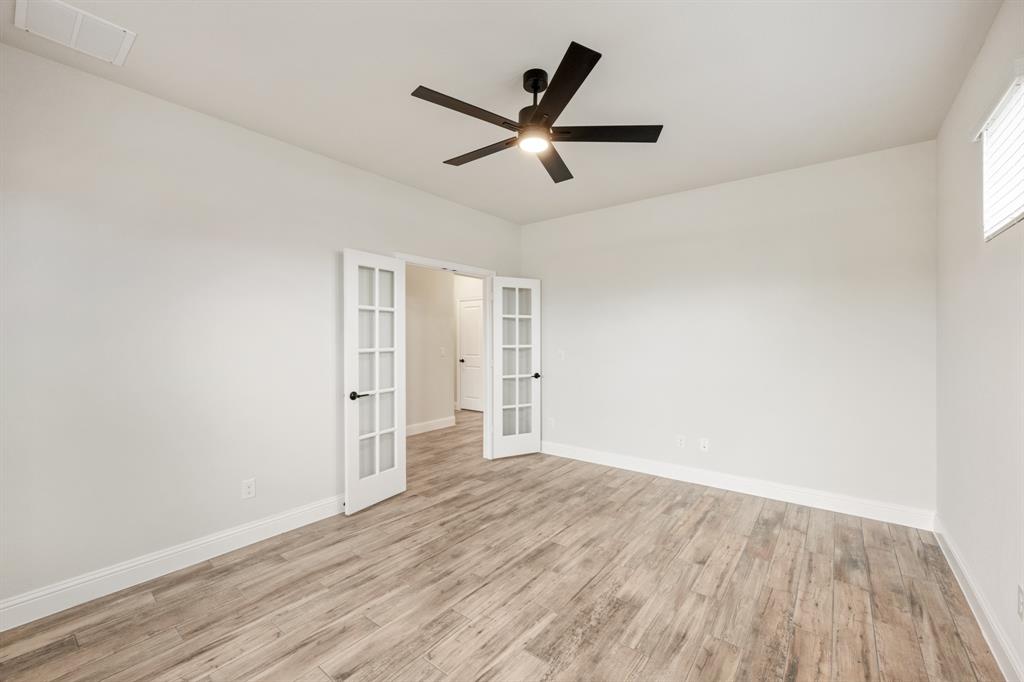 1630 Secco Way Rockwall, TX 75032 - Photo 7 of 40 a view of empty room with wooden floor and ceiling fan