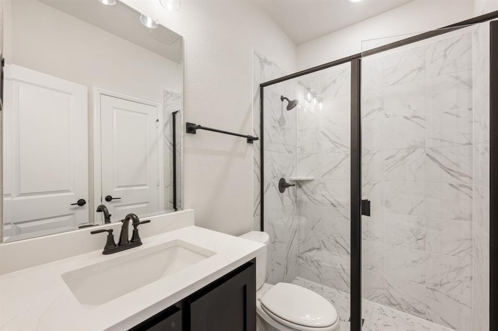 1630 Secco Way Rockwall, TX 75032 - Photo 9 of 40 a bathroom with a sink toilet and shower