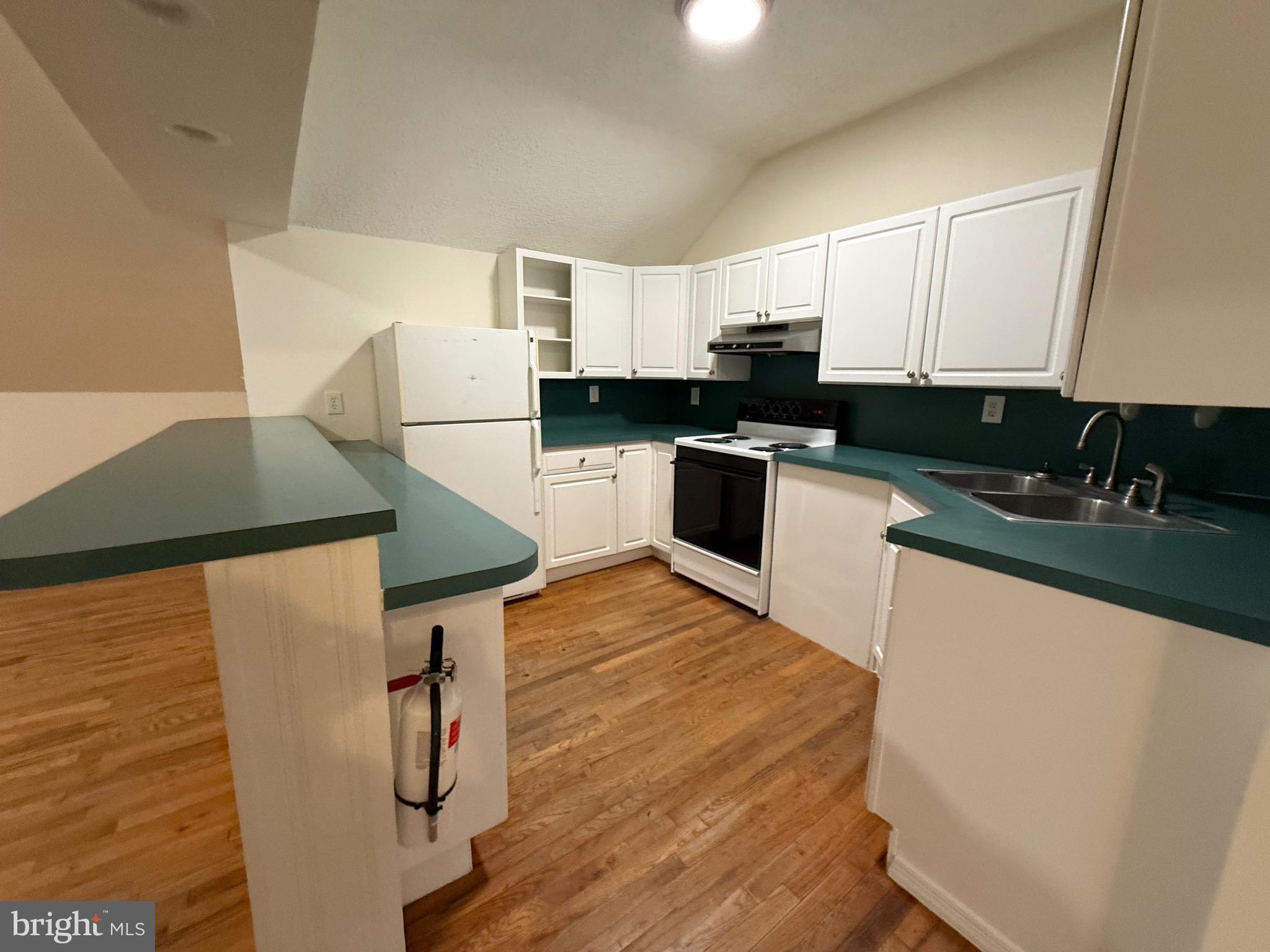 272 Shell Road Carneys Point, NJ 08069 - Photo 8 of 14 a kitchen with granite countertop a sink a stove top oven a chimney and a refrigerator