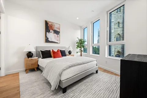 a bedroom with bed and a window