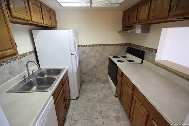 a kitchen with a sink stove and refrigerator