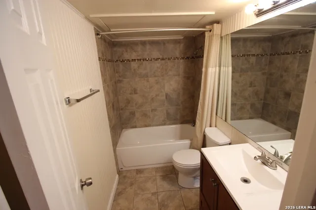 a bathroom with a sink a toilet and a bathtub