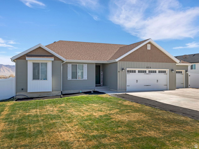 573 South Maxwell Drive Grantsville, UT 84029 - Photo 3 of 25 View of front facade with a garage, driveway, and roof with shingles