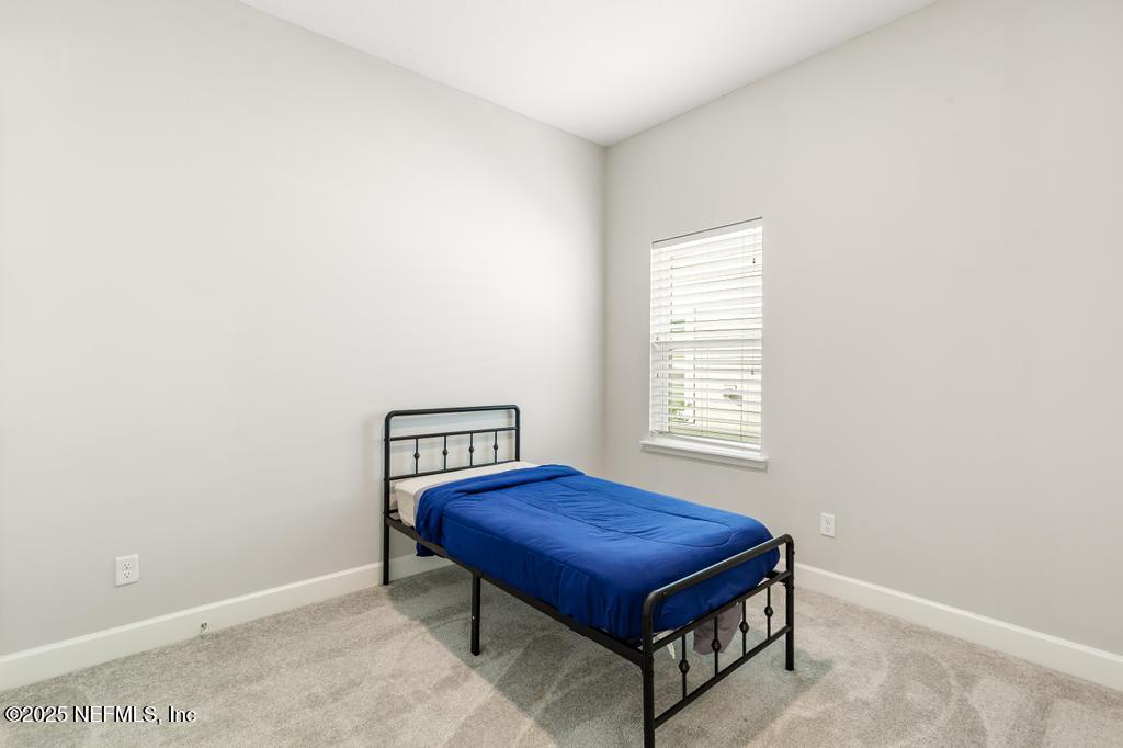 92 Alston Drive St. Augustine, FL 32092 - Photo 14 of 53 a bedroom with a bed and a window