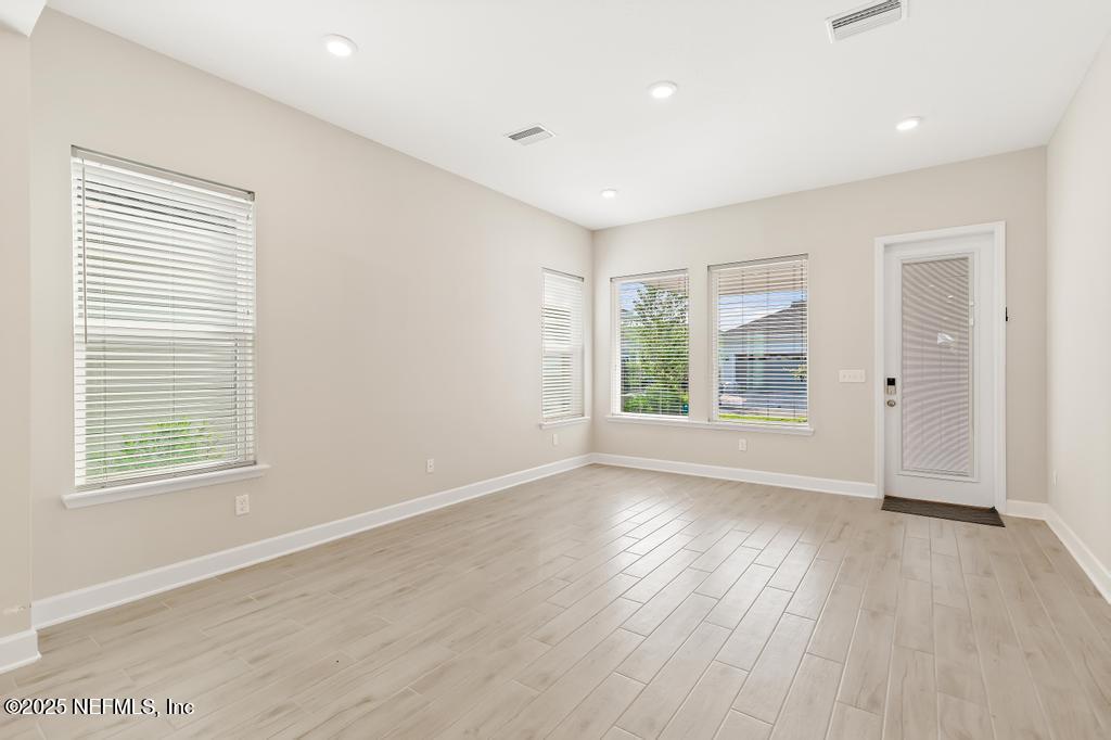 92 Alston Drive St. Augustine, FL 32092 - Photo 29 of 53 an empty room with wooden floor and windows