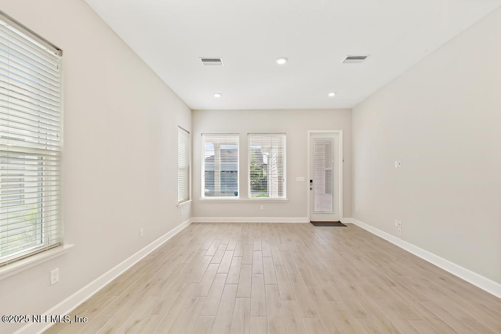 92 Alston Drive St. Augustine, FL 32092 - Photo 30 of 53 an empty room with wooden floor and windows