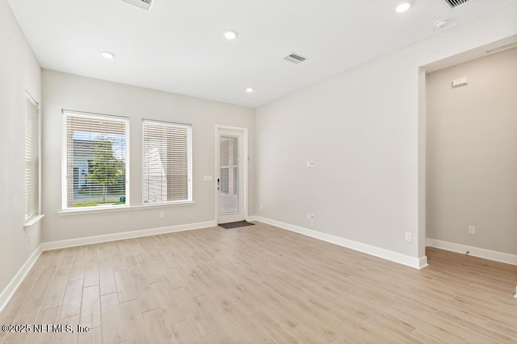 92 Alston Drive St. Augustine, FL 32092 - Photo 31 of 53 an empty room with wooden floor and windows