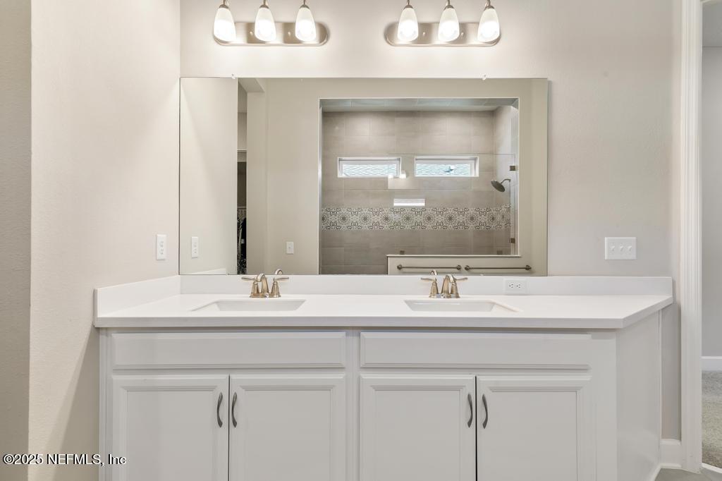 92 Alston Drive St. Augustine, FL 32092 - Photo 42 of 53 a bathroom with a sink vanity and a mirror