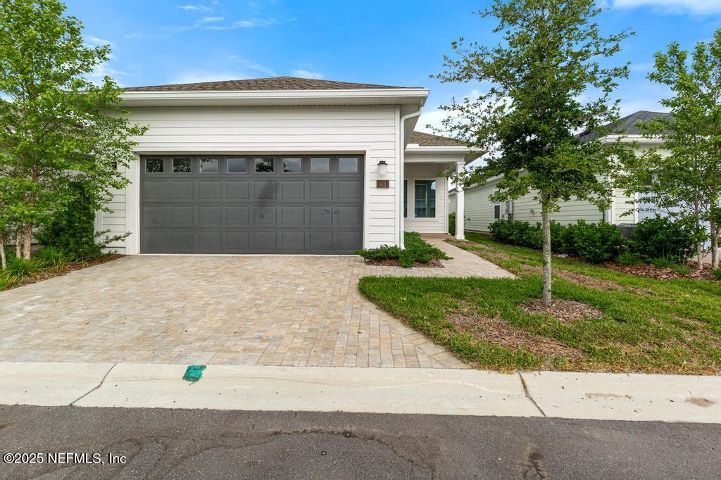 92 Alston Drive St. Augustine, FL 32092 - Photo 51 of 53 a front view of a house with a yard and garage