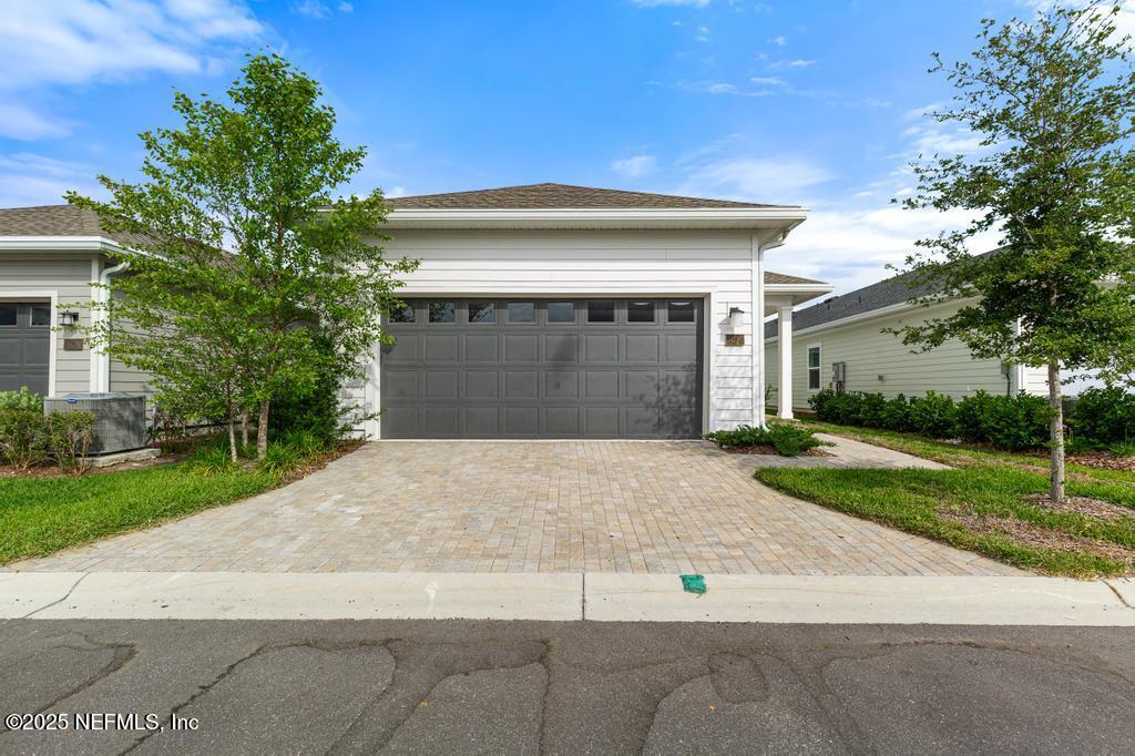 92 Alston Drive St. Augustine, FL 32092 - Photo 52 of 53 a front view of a house with a yard and garage