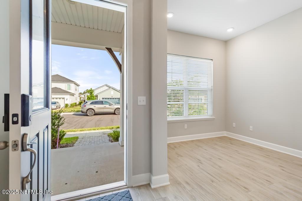 92 Alston Drive St. Augustine, FL 32092 - Photo 7 of 53 a view of hallway with livingroom and wooden floor