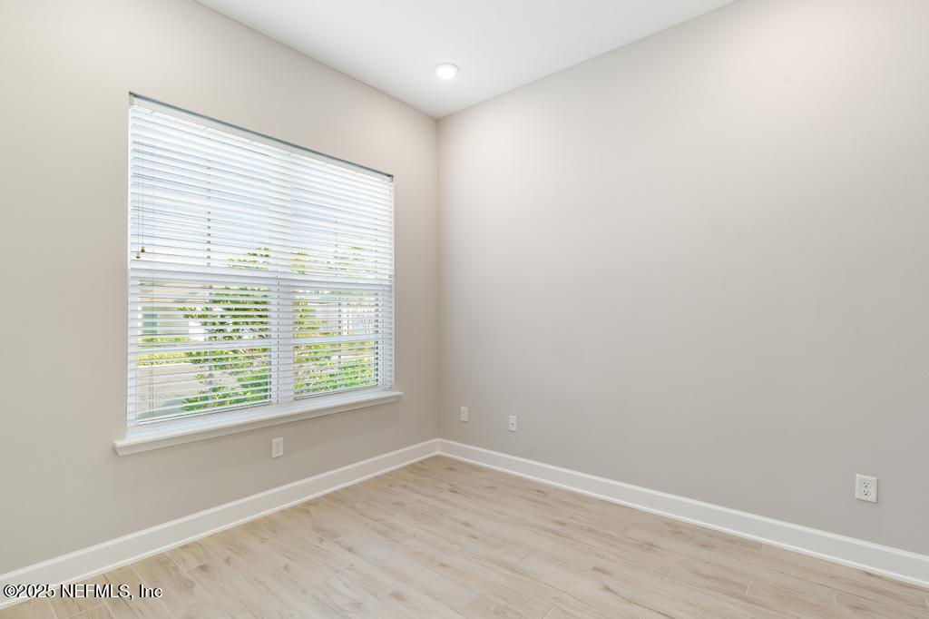 92 Alston Drive St. Augustine, FL 32092 - Photo 8 of 53 a view of an empty room with wooden floor and a window