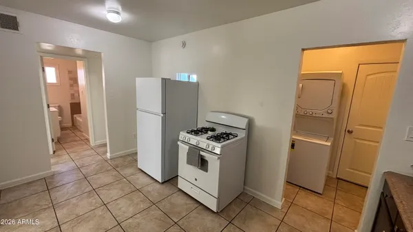 a kitchen with stainless steel appliances granite countertop a refrigerator and a stove