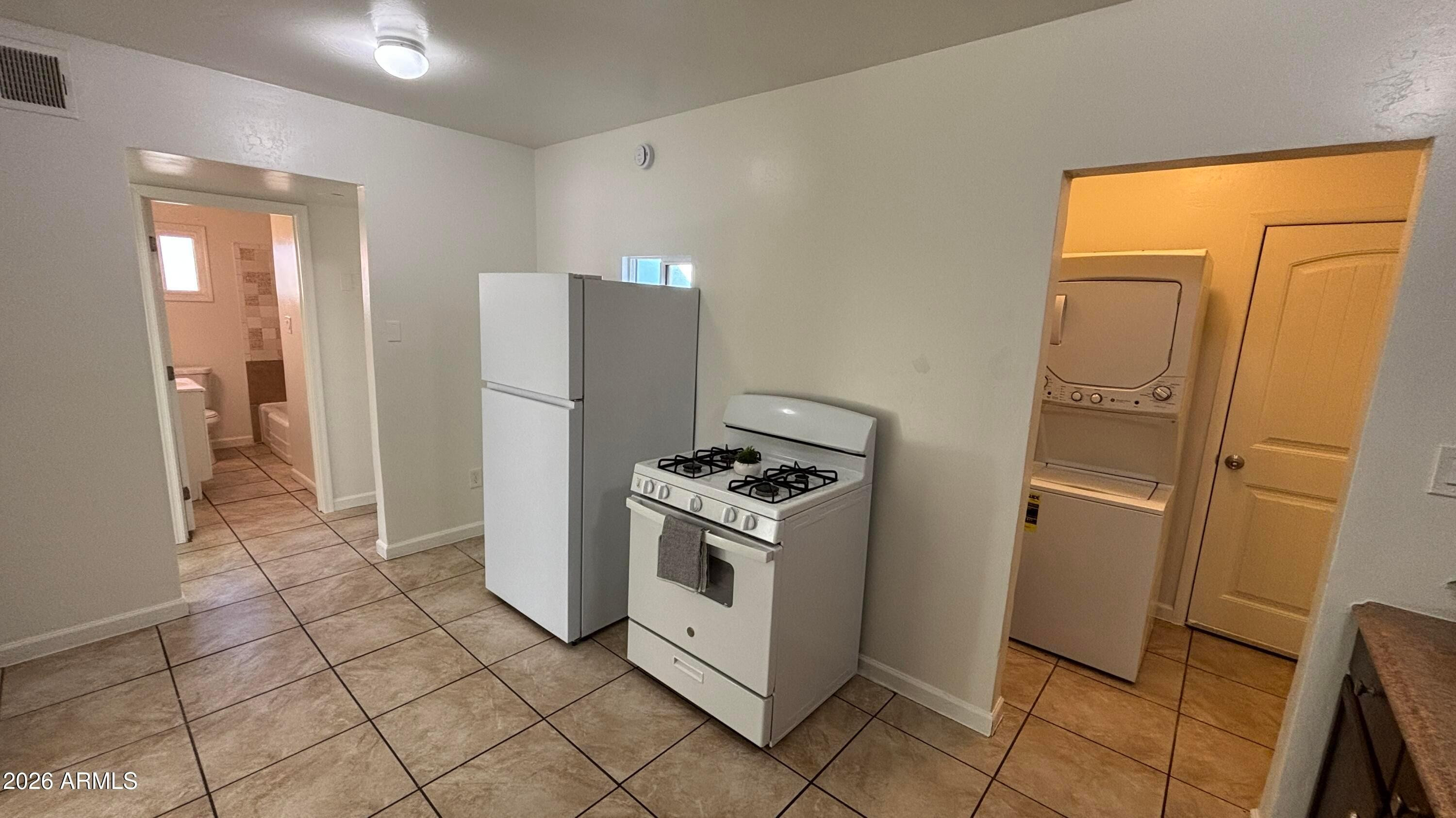 419 North 20th Street, Unit 2 Phoenix, AZ 85006 - Photo 7 of 15 a kitchen with stainless steel appliances granite countertop a refrigerator and a stove