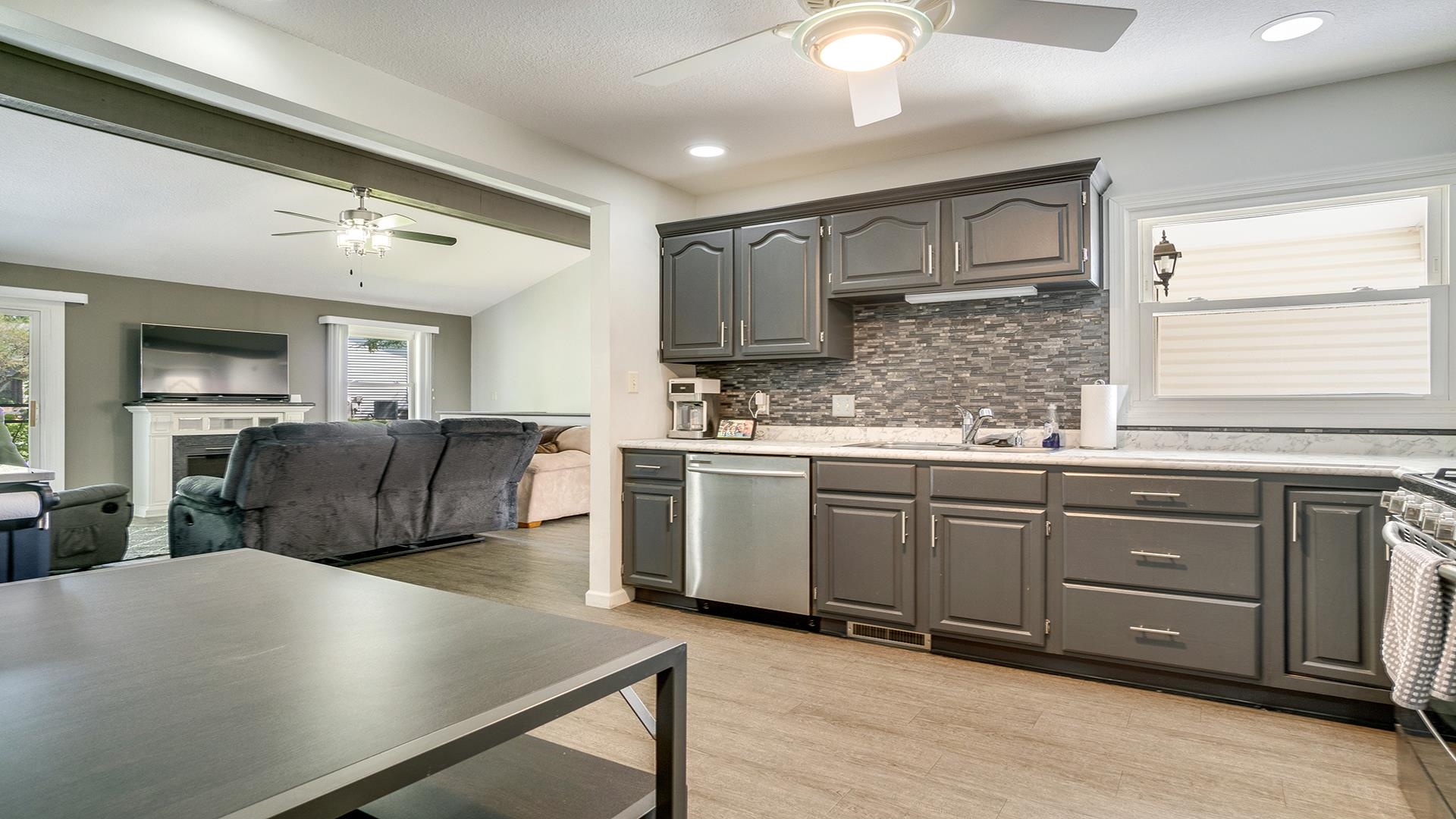 1065 Idle Oak Run Dixon, IL 61021 - Photo 12 of 44 a kitchen with kitchen island granite countertop a stove a sink a refrigerator dining table and chairs