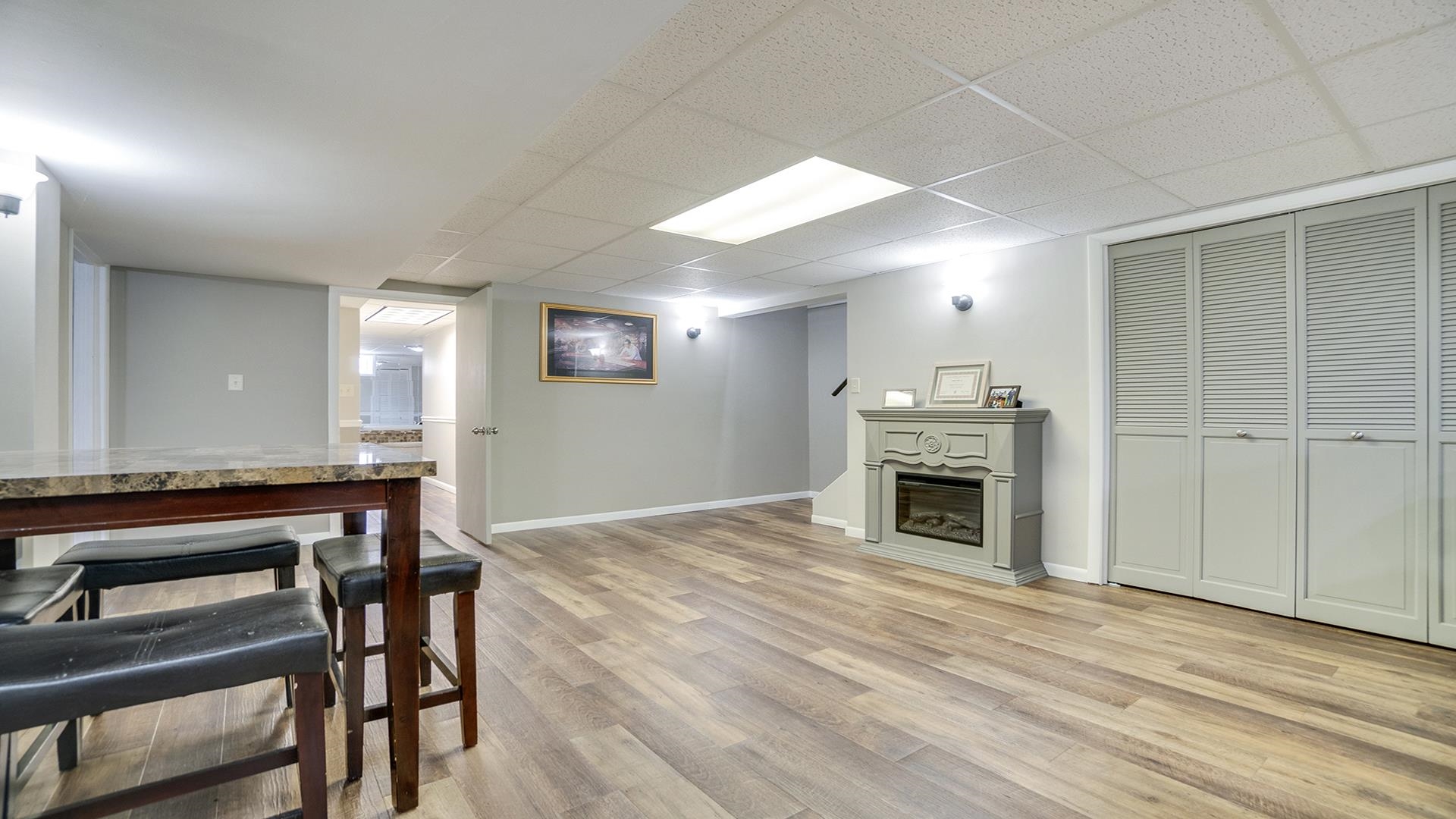 1065 Idle Oak Run Dixon, IL 61021 - Photo 22 of 44 a view of a livingroom with a fireplace a chandelier a wooden table and chairs