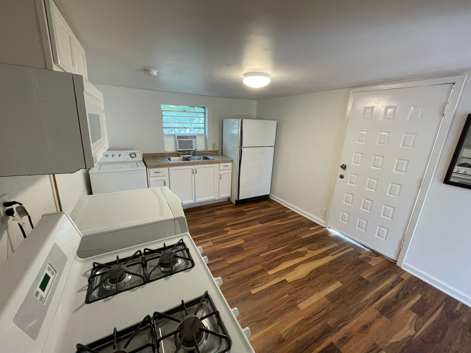 6404 Ponca Street, Unit B Austin, TX 78741 - Photo 4 of 17 a kitchen with sink a stove and refrigerator