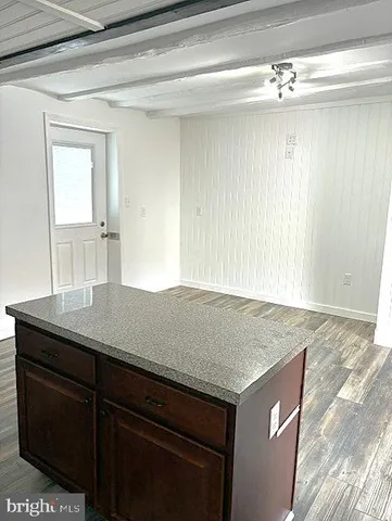 a view of a sink a mirror and cabinets