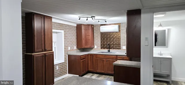 a bathroom with a sink a large mirror and a bathtub