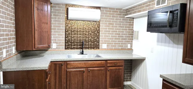 a kitchen with kitchen island granite countertop cabinets and window