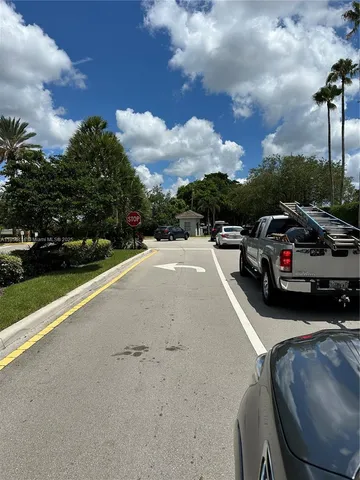 a view of a city street with a car parked on the roadside