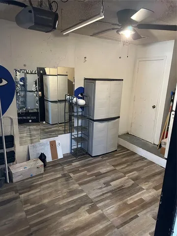 a view of kitchen with refrigerator and microwave