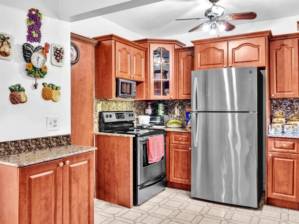2347 Southwest 18th Street Miami, FL 33145 - Photo 14 of 46 a kitchen with stainless steel appliances granite countertop a refrigerator and a stove top oven