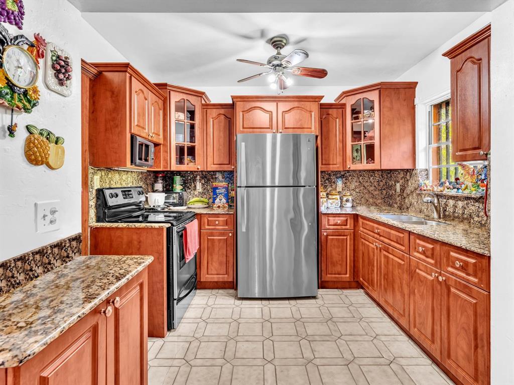 2347 Southwest 18th Street Miami, FL 33145 - Photo 15 of 46 a kitchen with stainless steel appliances granite countertop a refrigerator a stove and a sink