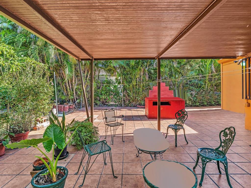 2347 Southwest 18th Street Miami, FL 33145 - Photo 31 of 46 a view of a patio with a table chairs and a backyard