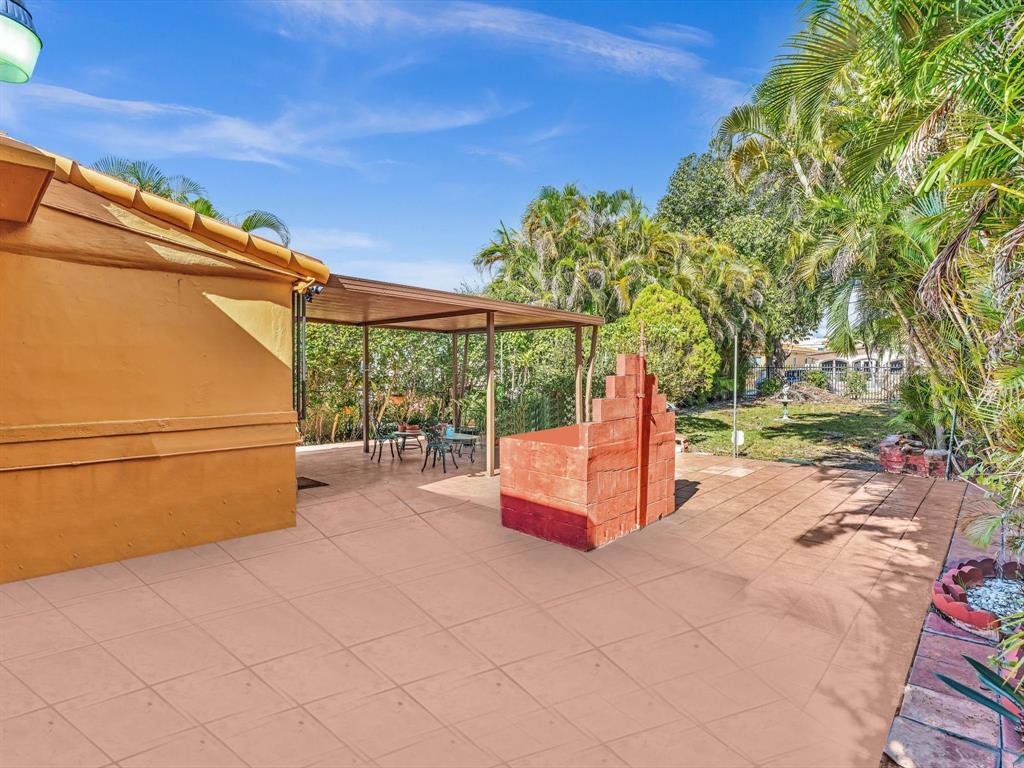 2347 Southwest 18th Street Miami, FL 33145 - Photo 32 of 46 a backyard of a house with a yard and outdoor seating