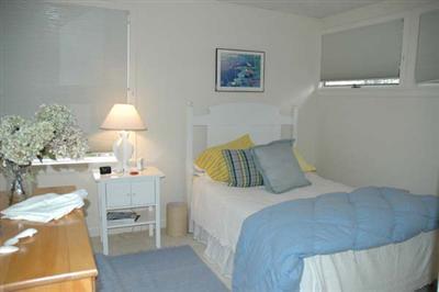 40 Mashnee Road Bourne, MA 02532 - Photo 12 of 12 a bed room with a bed and a chair