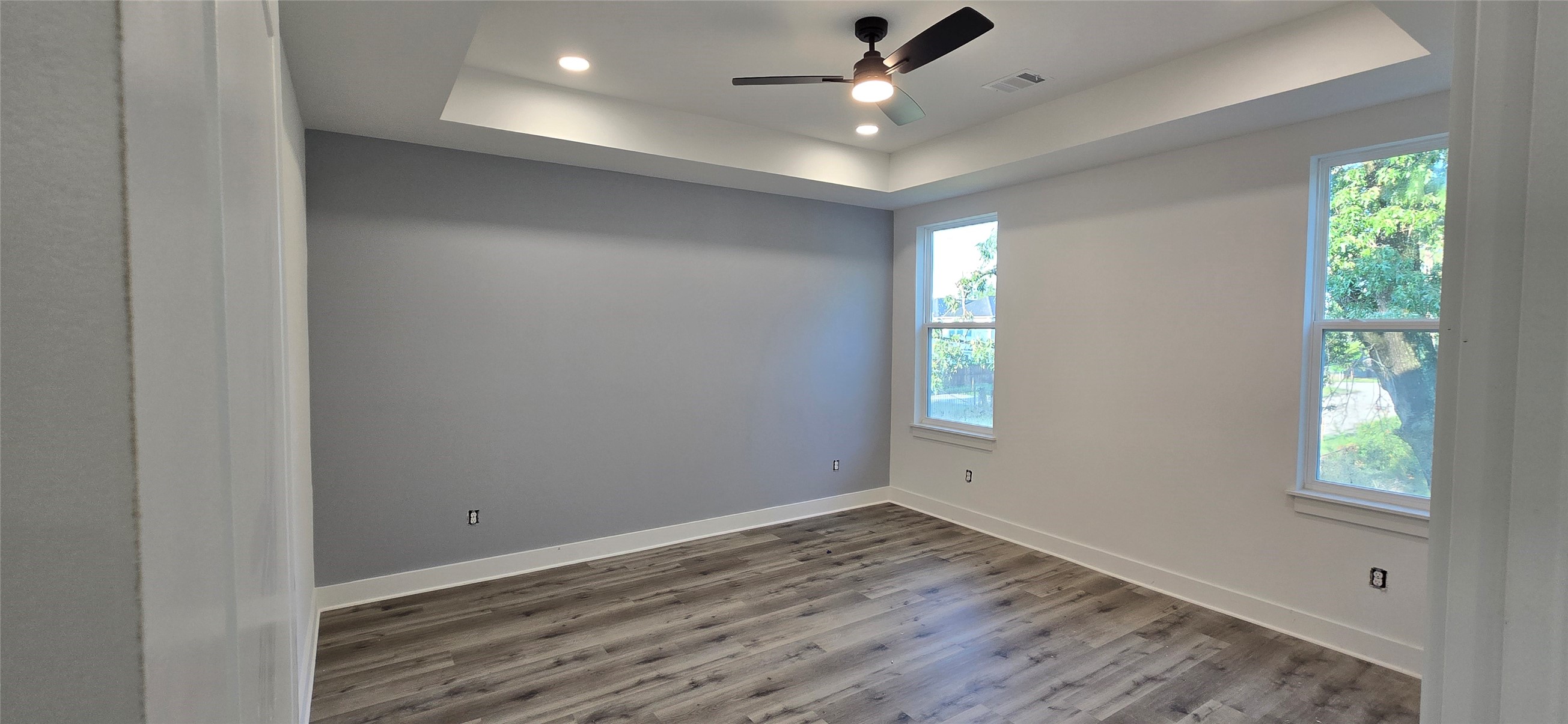 4922 Hoover Street, Unit F Houston, TX 77092 - Photo 11 of 26 Primary bedroom with coffered ceiling and adjoining master bath suite.
