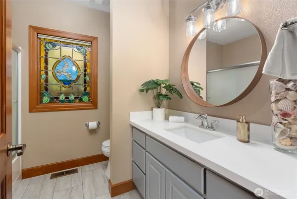 a bathroom with a sink a vanity and a mirror