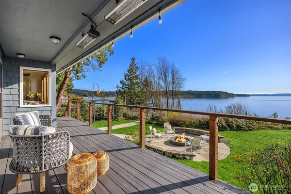 a view of a patio with couches chairs dining table and chairs with wooden floor