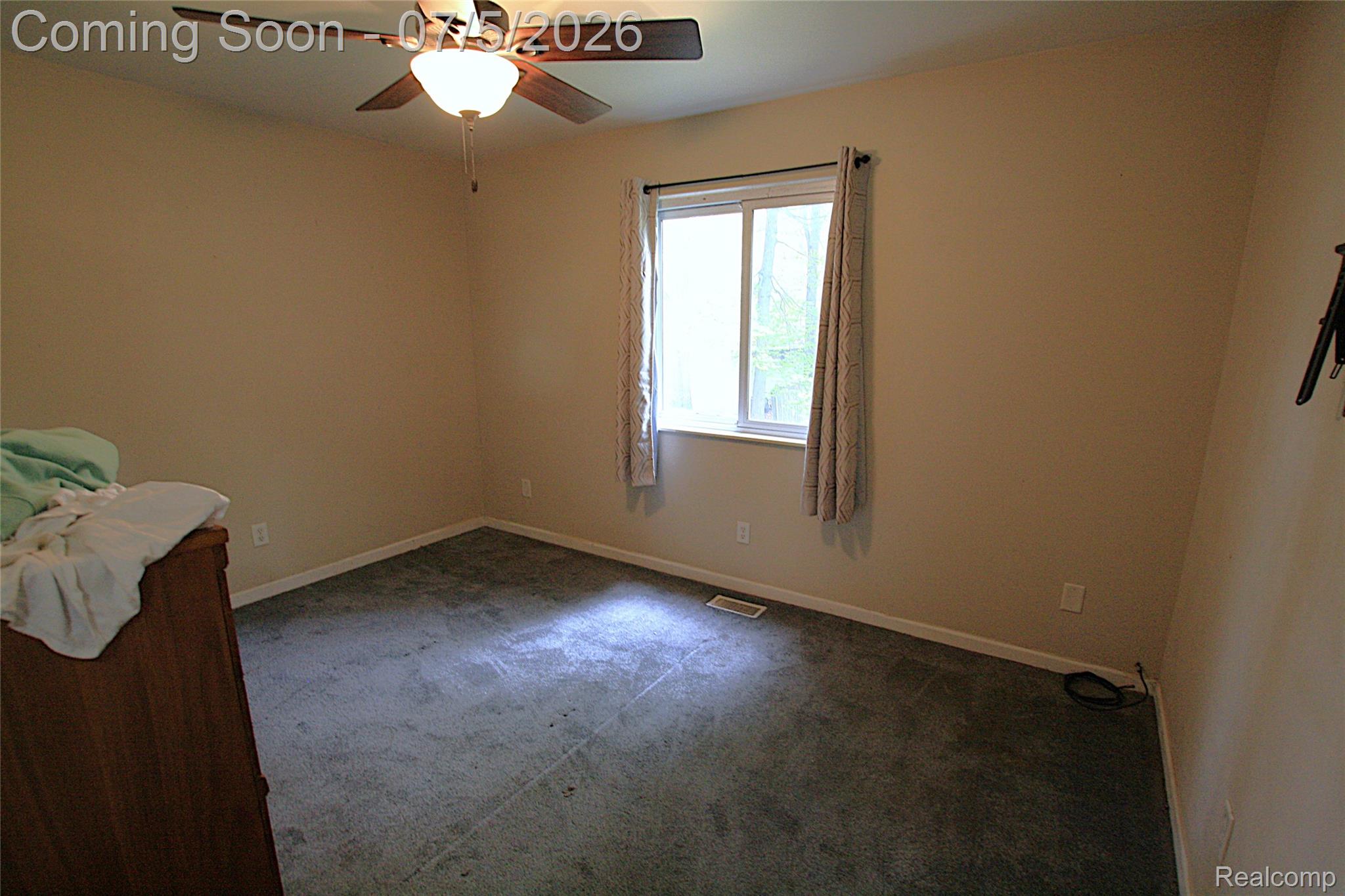 12403 Willard Road Montrose, MI 48457 - Photo 23 of 30 Spare room featuring carpet flooring and ceiling fan