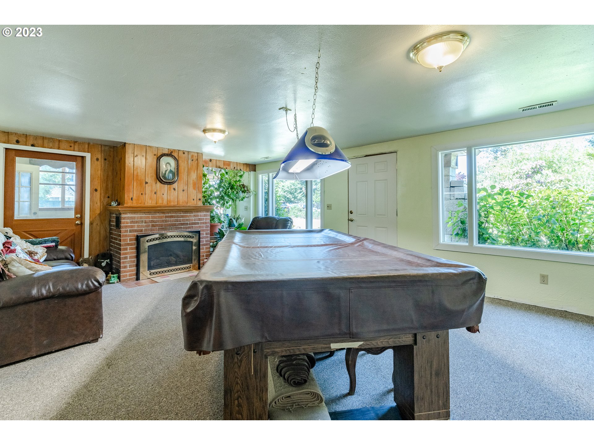 6585 Main Street Springfield, OR 97478 - Photo 13 of 30 a living room with furniture a fireplace and a large window