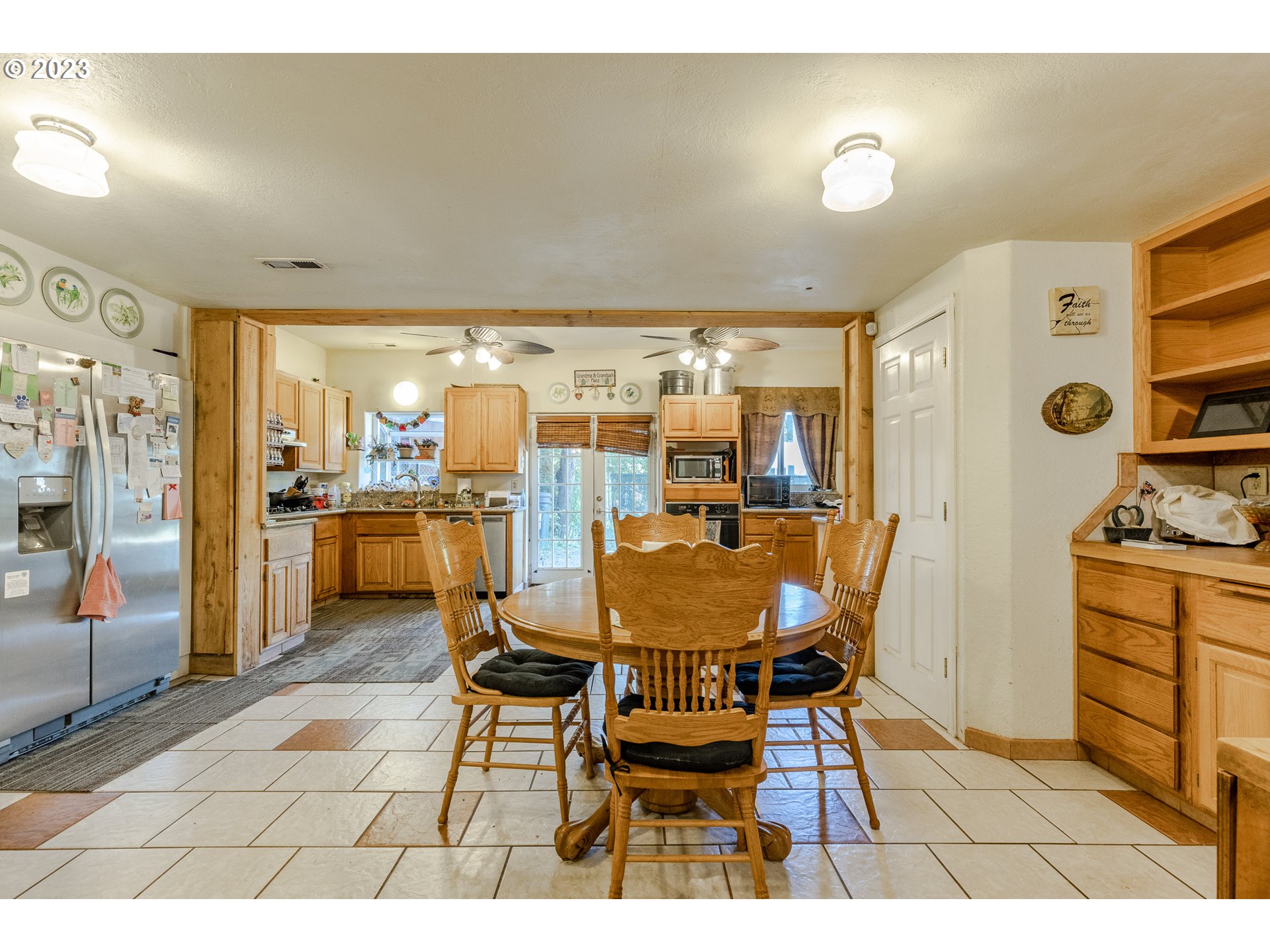 6585 Main Street Springfield, OR 97478 - Photo 15 of 30 a dining room filled a chandelier and kitchen view