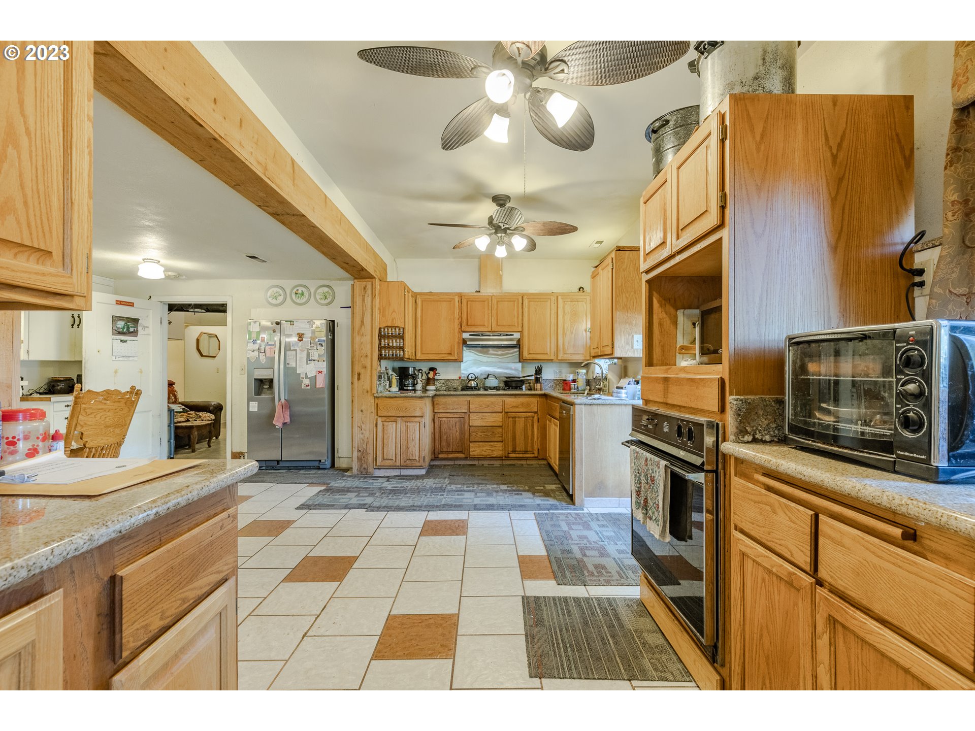 6585 Main Street Springfield, OR 97478 - Photo 21 of 30 a kitchen with stainless steel appliances kitchen island granite countertop a sink and cabinets