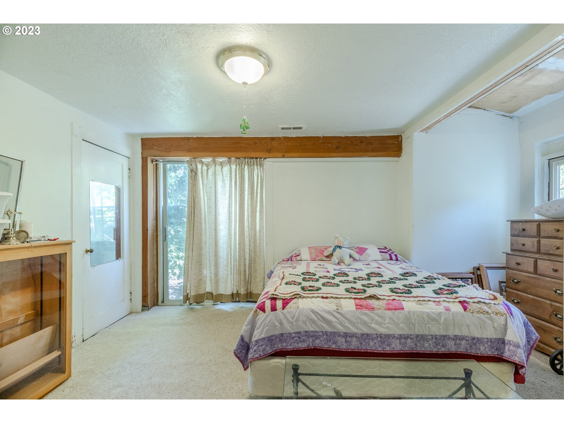6585 Main Street Springfield, OR 97478 - Photo 23 of 30 a bedroom with a bed and a television